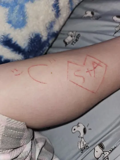 Cute 18 year old with letters craved in ankles