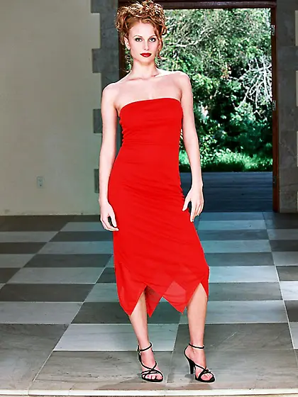 Cuddly red haired babe Anya bares her sexy red dress showing her