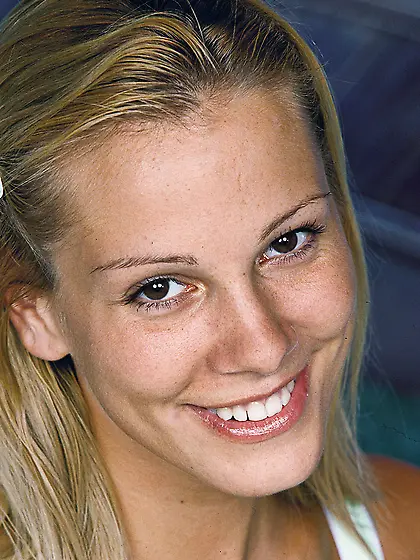 Beautiful blonde chick Sandy strips her white thongs on the bed