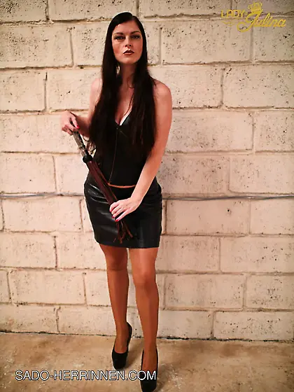 Mistress Lady Julina wears leather skirt and pantyhose