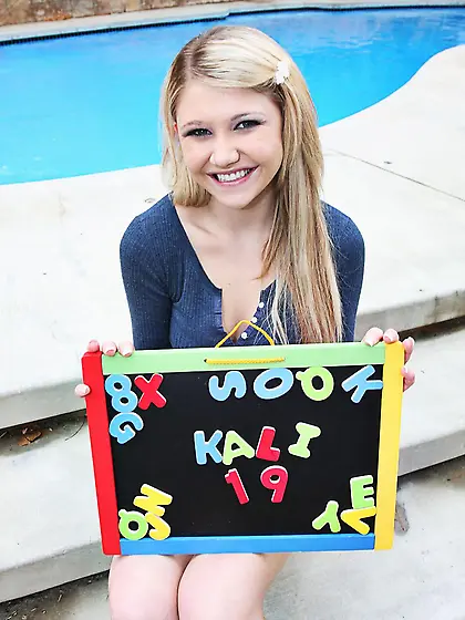 Innocent looking teen girl Kali Lane with playful eyes gives hea