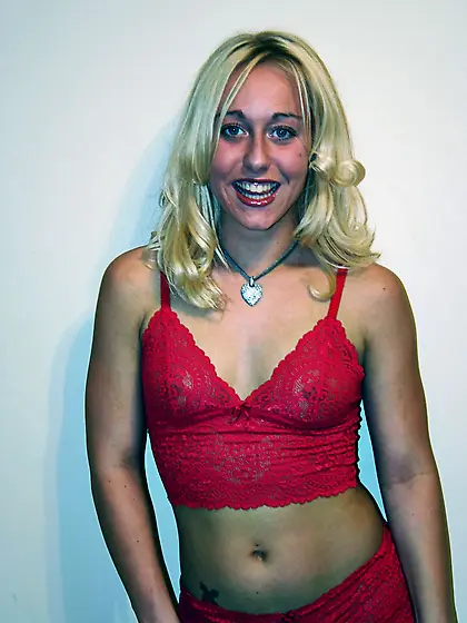 Beautiful blonde babe Goldie Cox strips her red lingerie and sho