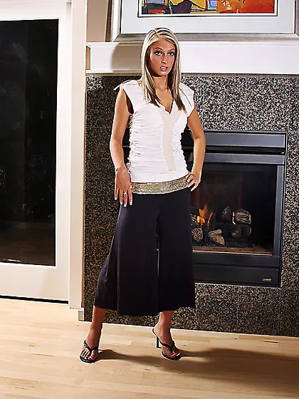 Sitting near the fireplace Kirsten Andrews shows off nude body a