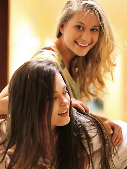 College-aged cuties taking off their clothes in a hotel corridor