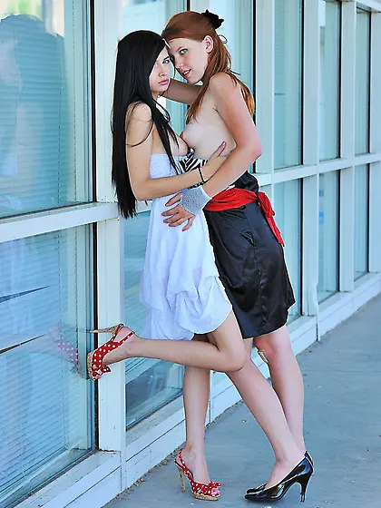 Dress-wearing lezzies make out in public and enjoy some fingerin