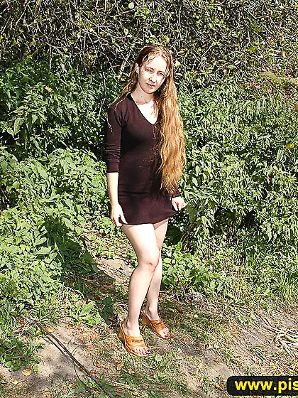 Outdoor pissing in the summer forest on the road