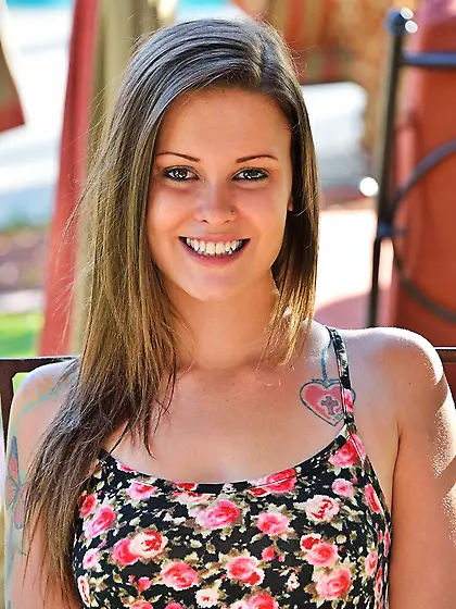 Teen gal takes off her colorful dress outdoors