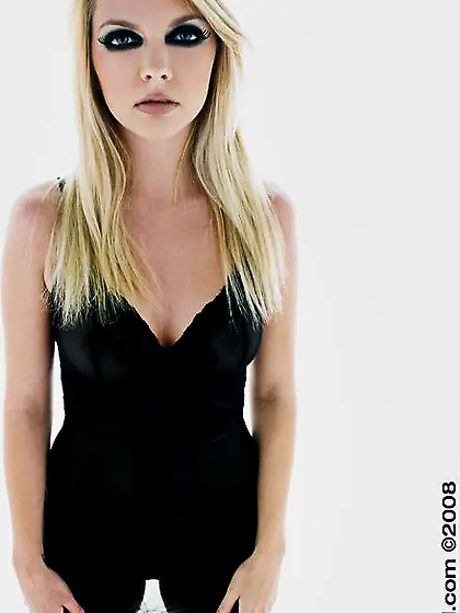 Blonde Jana Jordan with rich make-up fingers her pink pussy and