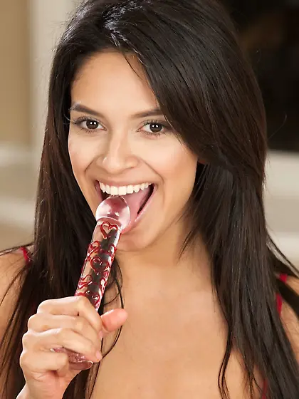 Dark-haired Latina sticks a glass toy up that dripping pussy