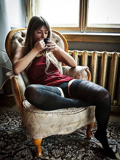 Olivia K strips down to her black stockings today.